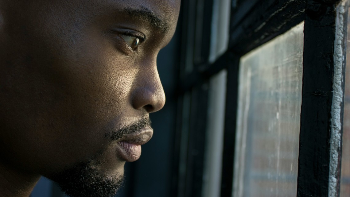 Man Looking Out Window